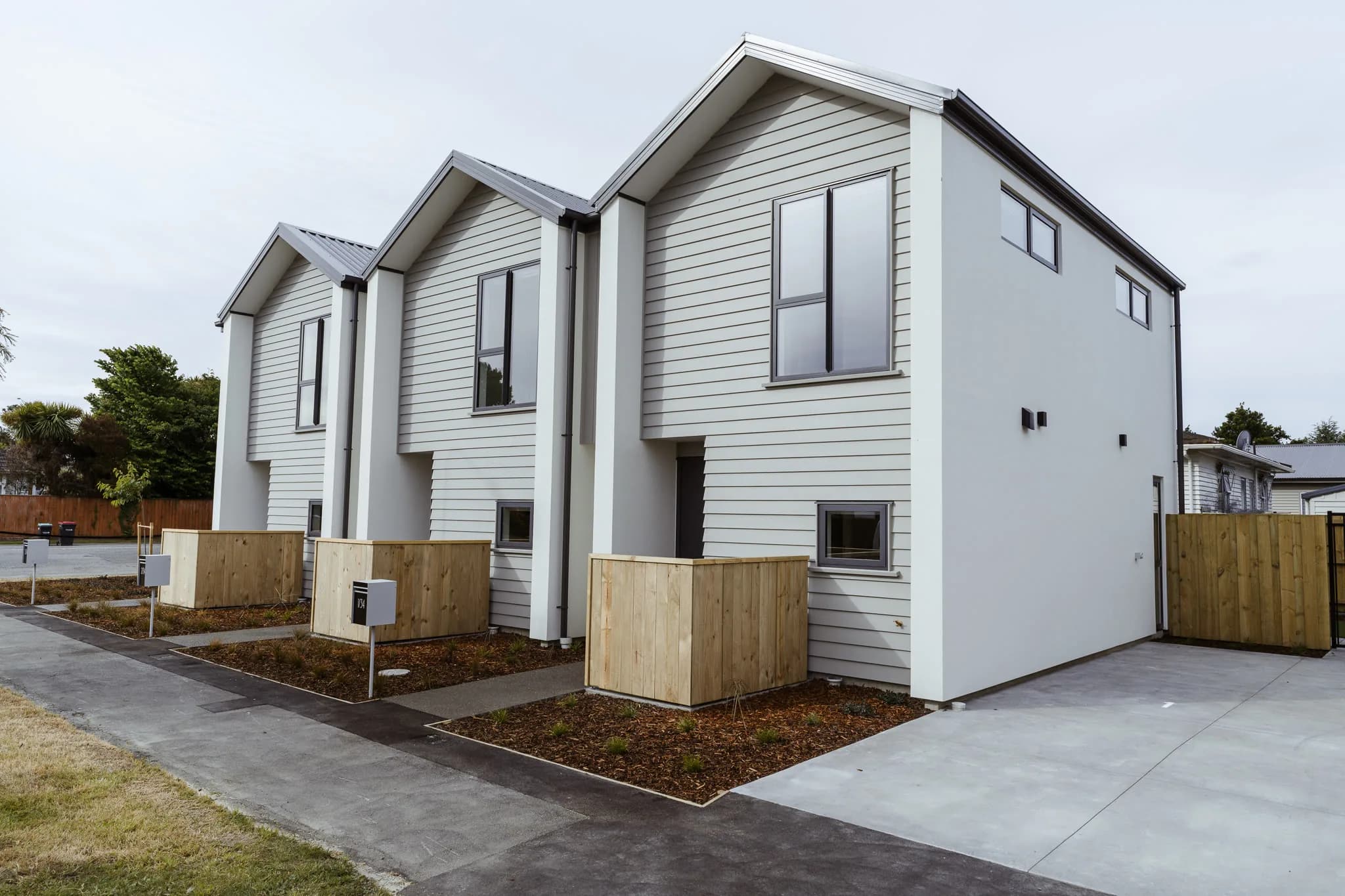 154 Edinburgh Street — white weatherboard townhouses with gable roofs