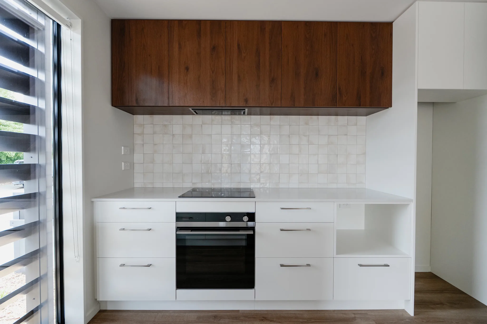 120 Hastings Street — kitchen with tile splashback and walnut uppers