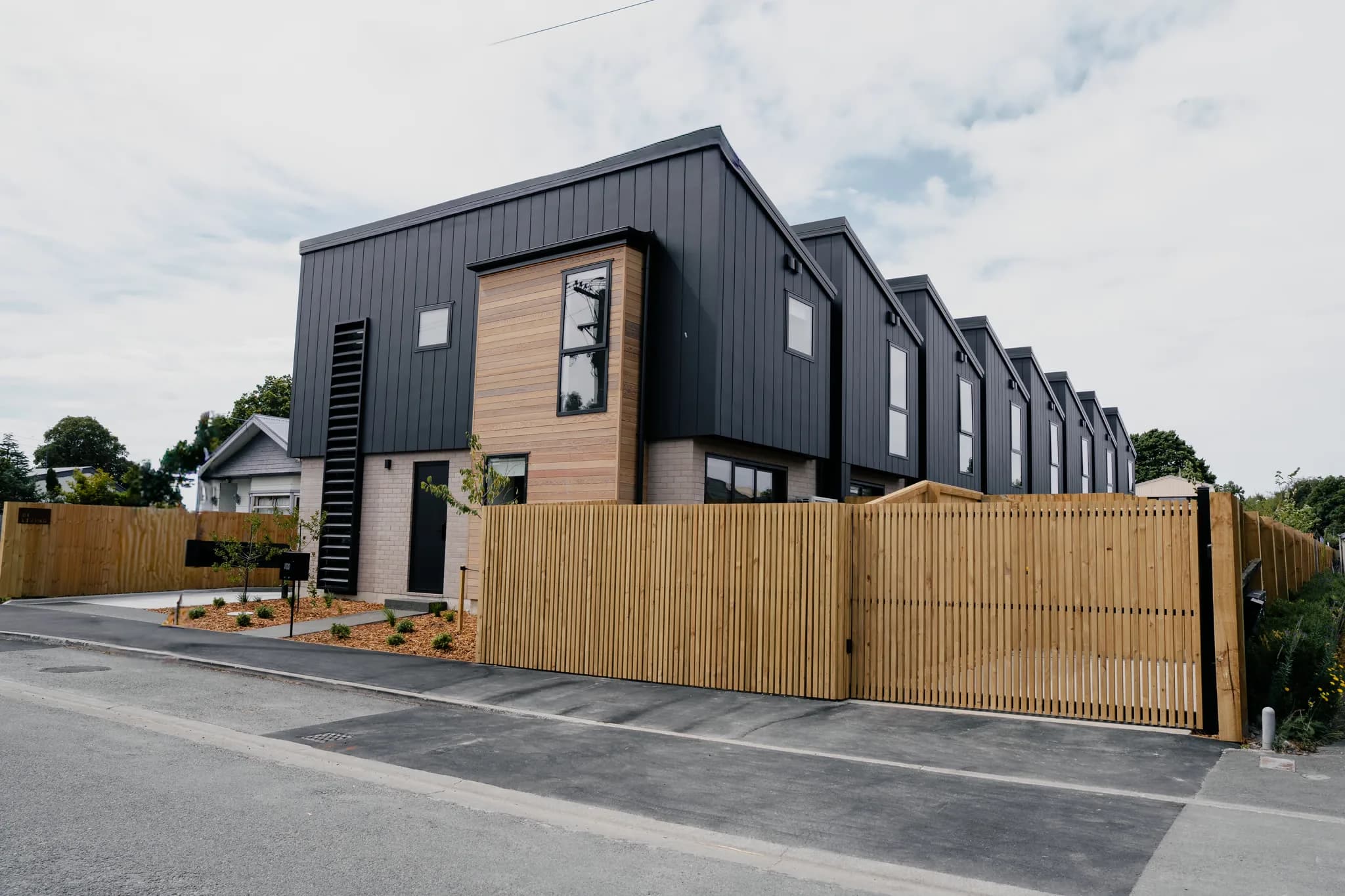 120 Hastings Street — dark-clad units with cedar and brick detail