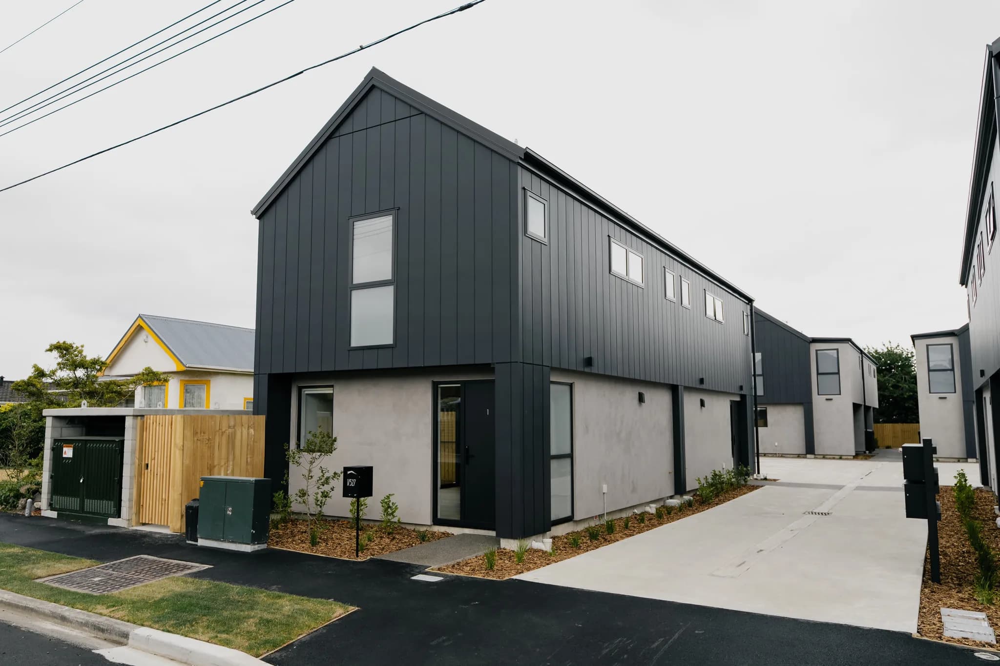527 Hereford Street — dark cladding and gable detail from corner