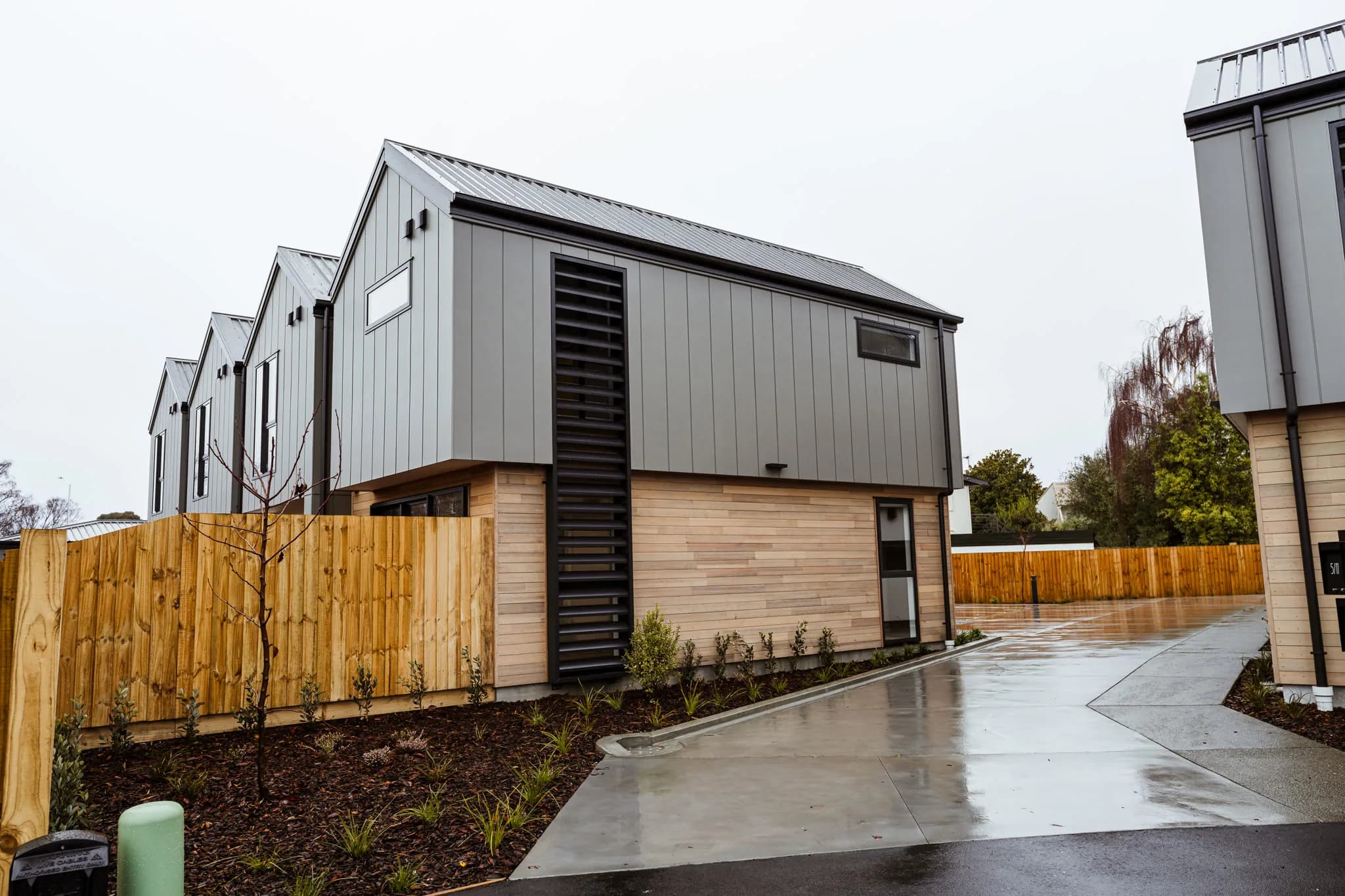 Trist Place — cedar and grey cladding from driveway
