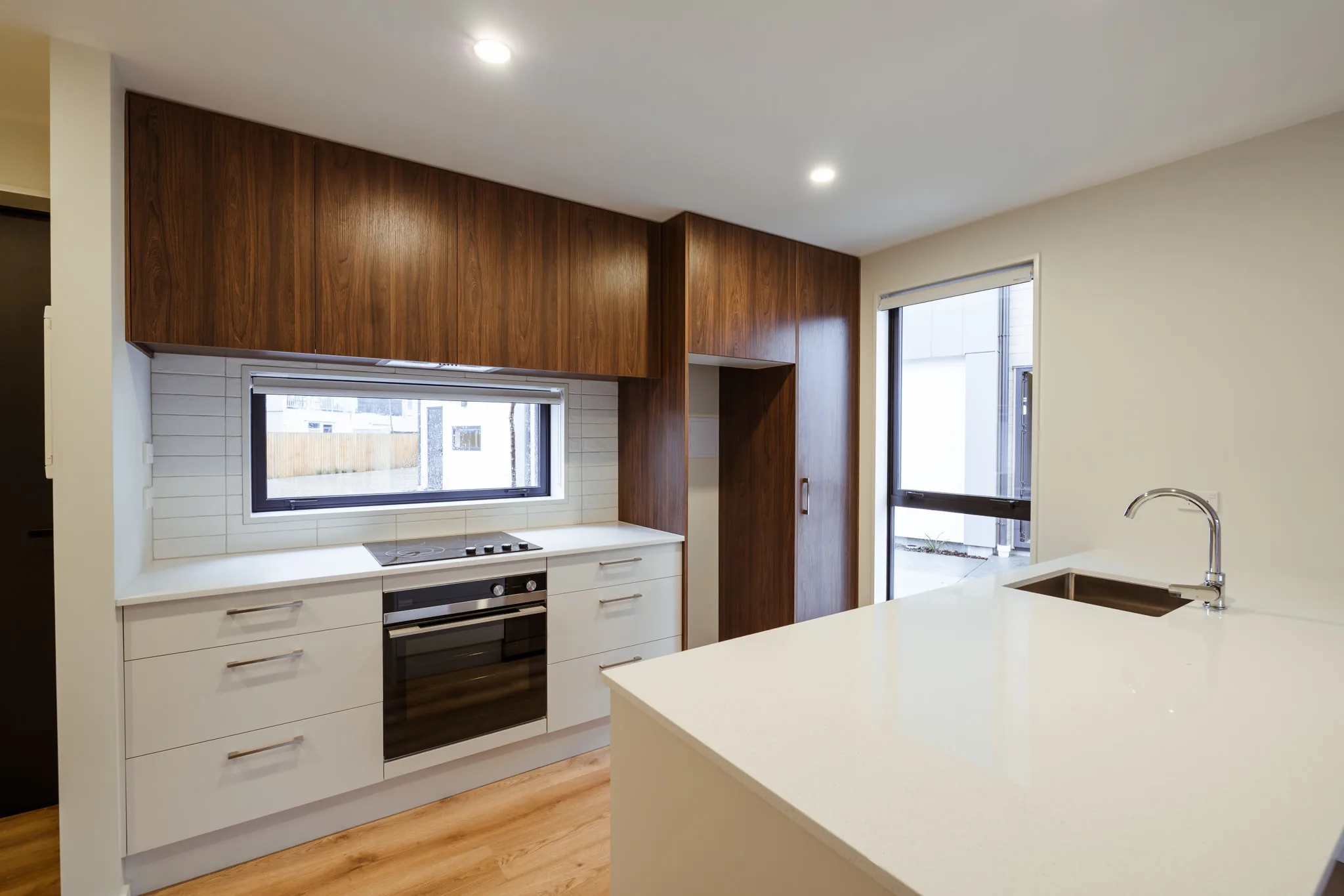 Trist Place — modern kitchen with walnut cabinetry and stone benchtops