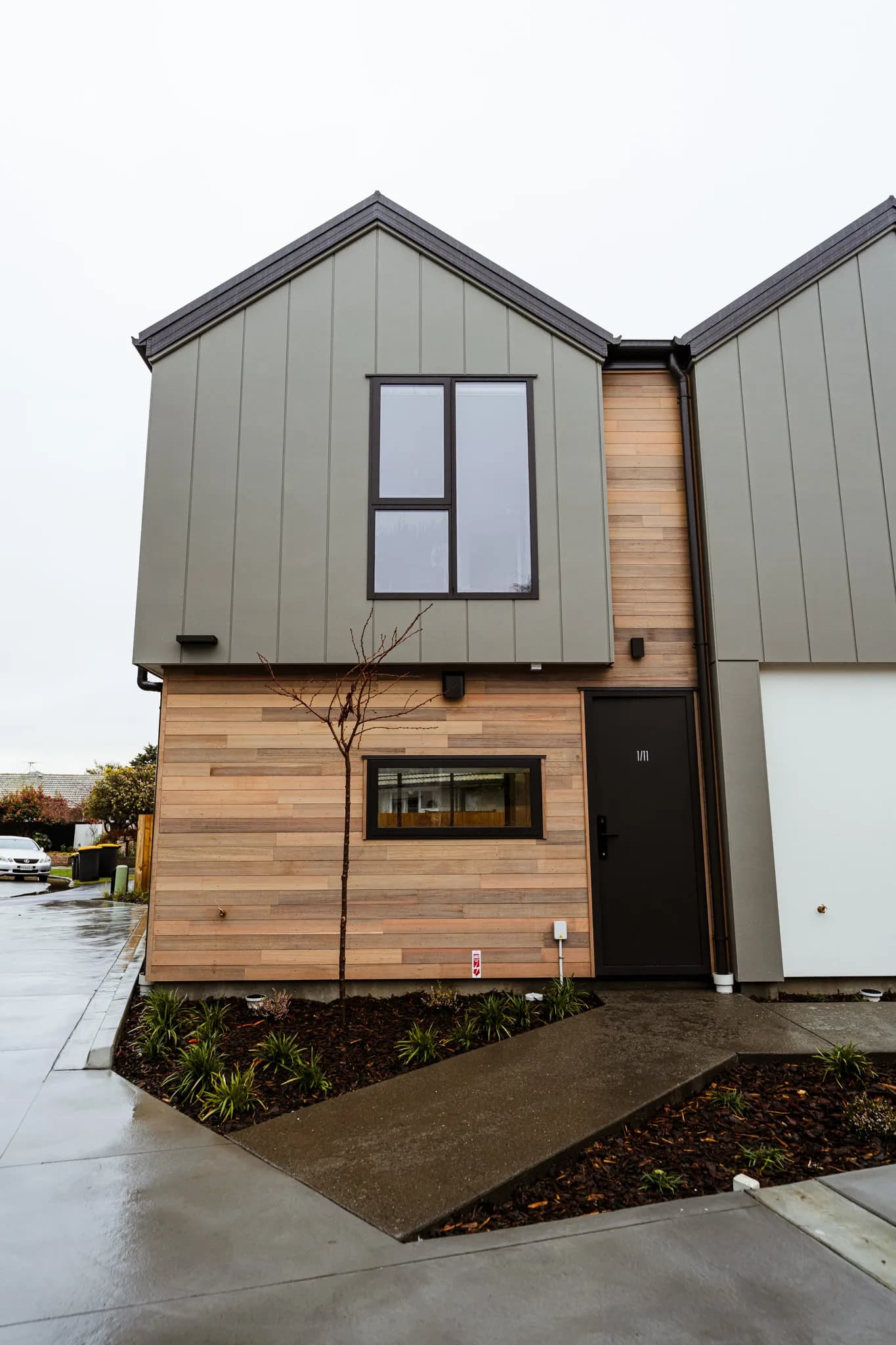 Trist Place — cedar and grey cladding townhouse entrance